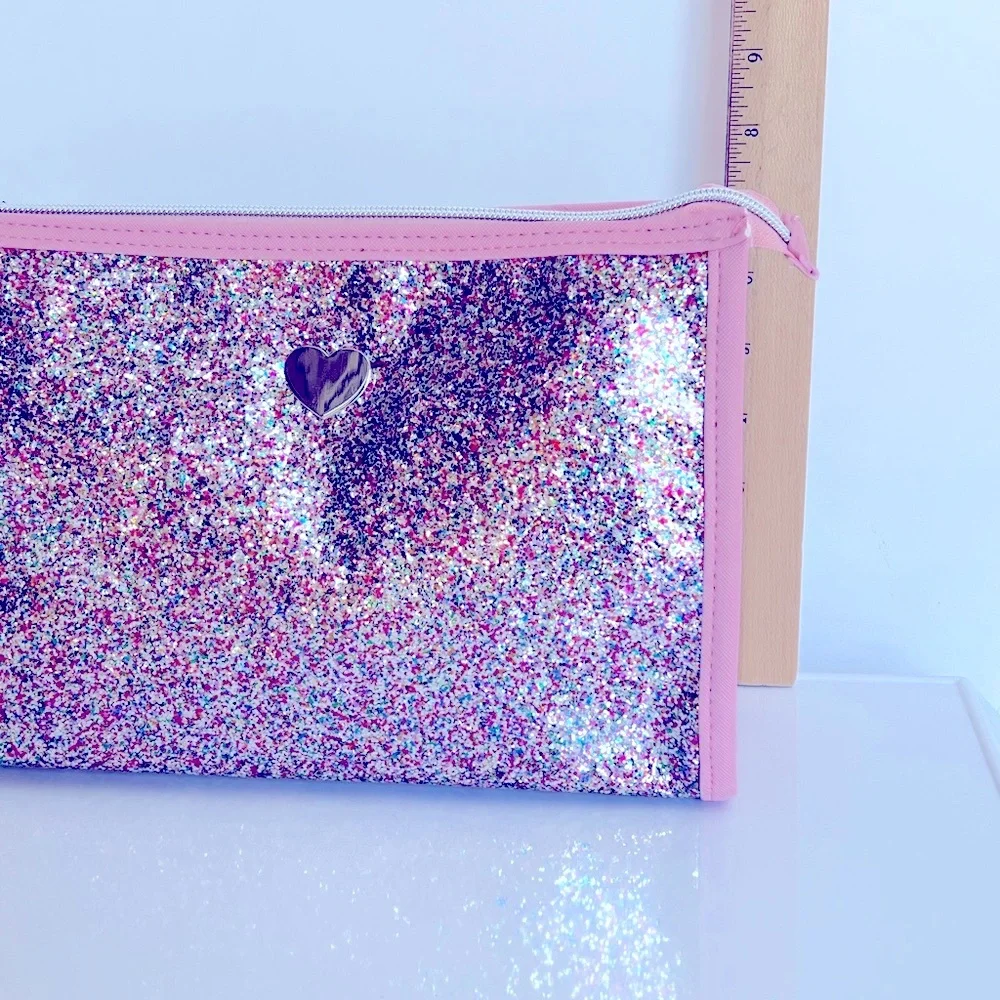 Pink Glitter Cosmetic Bag with a Silver Heart on Clear Vinyl & a Silver Zipper.